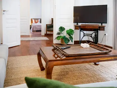 a living room with a coffee table and a flat screen tv at The Arcade in Athens