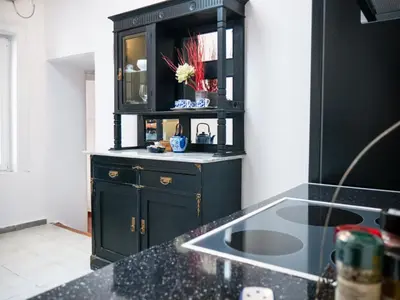 a kitchen with a black cabinet and a sink at The Arcade in Athens