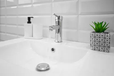 a sink with a faucet with water coming out of it at Athenian center apartments in Athens