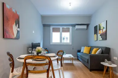 a living room with a table and a couch at Athenian center apartments in Athens