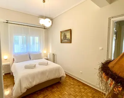 a bedroom with a bed with two towels on it at Athenian Condo in Athens