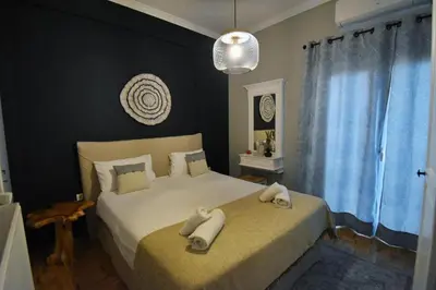 a bedroom with a bed with two towels on it at Seven Seconds Away Apartment in Athens