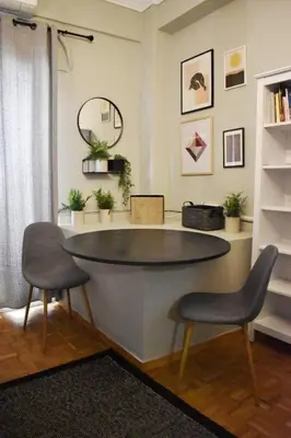 a living room with a table and two chairs at Seven Seconds Away Apartment in Athens