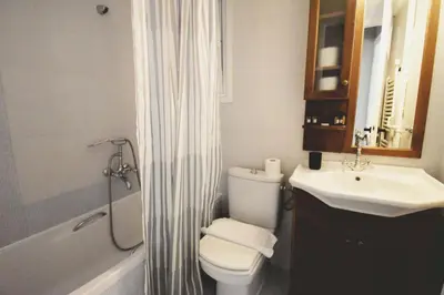 a bathroom with a toilet and a sink and a shower at Seven Seconds Away Apartment in Athens