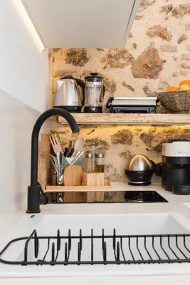a kitchen with a white stove top oven at Athena Luxury Studios in Athens
