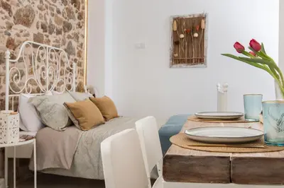 a living room with a table and a couch at Athena Luxury Studios in Athens