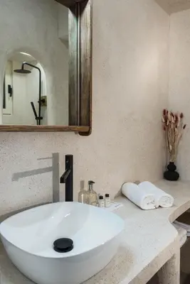 a bathroom with a white sink and a mirror at Athena Luxury Studios in Athens