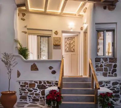 a staircase leading to a home with a stone wall at Athena Luxury Studios in Athens
