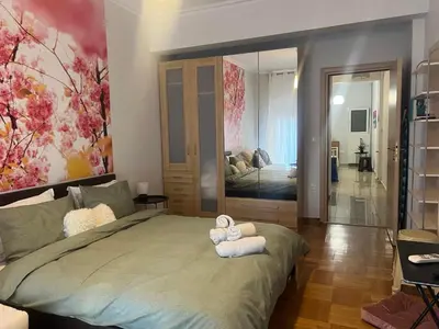 a bedroom with a large bed with towels on it at Acropolis Urban Flat in Athens