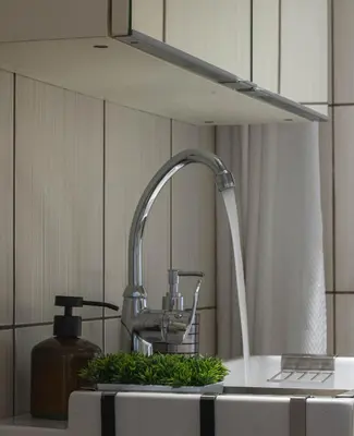 a kitchen sink with a water faucet at Acropolis Urban Flat in Athens