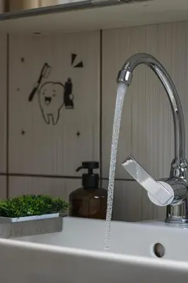 a kitchen sink with water coming from a faucet at Acropolis Urban Flat in Athens