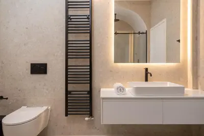 a bathroom with a sink and a toilet and a mirror at Upscale Athens Luxury Penthouse in Athens