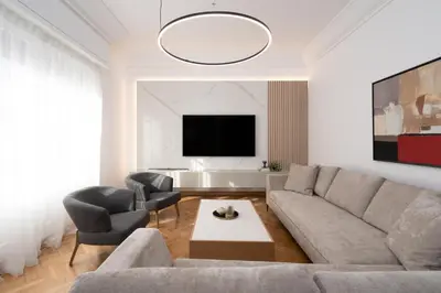 a living room with a couch and chairs and a tv at Upscale Athens Luxury Penthouse in Athens