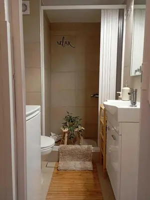 a bathroom with a toilet and a plant in it at Cozy Apartment with Private Courtyard , Near Syngrou-Fix Metro Station in Athens