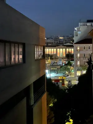 a view of a city at night from a building at VJ Athens in Athens