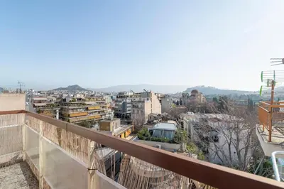 a view of a city from a balcony at Acropolis from my bed in Athens