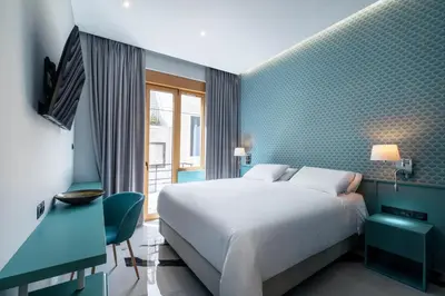 a bedroom with a white bed and a blue wall at Athens Feeling in Athens