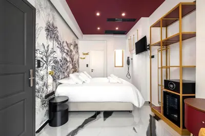 a bedroom with a white bed and a tv at Athens Feeling in Athens