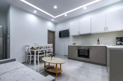 a kitchen and living room with a couch and a table at Renovated 2BD house close to Pireus port in Piraeus