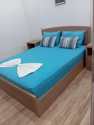 a bedroom with a bed with blue sheets and pillows at Renovated 2BD house close to Pireus port in Piraeus