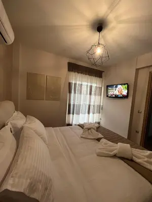 a bedroom with a large bed with a tv on the ceiling at Palmyra Athens in Athens