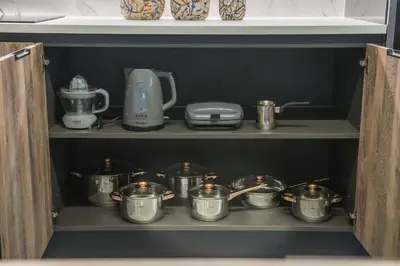 a shelf with pots and pans in a kitchen at Palmyra Athens in Athens