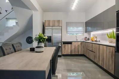 a kitchen with a large wooden table in a room at Palmyra Athens in Athens