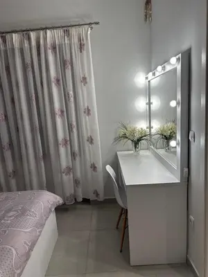 a bathroom with a sink and a mirror and a bed at A&A Apartment in Piraeus