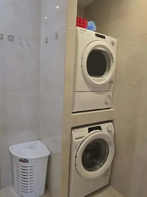a washing machine and a washer in a bathroom at A&A Apartment in Piraeus
