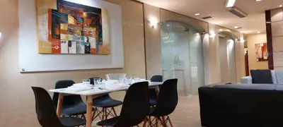 a dining room with a white table and black chairs at Deluxe Apartment 12BD 6BATH in Athens