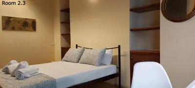 a bedroom with a bed with towels on it at Deluxe Apartment 12BD 6BATH in Athens