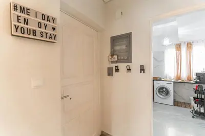 a white door in a room with a washing machine at AcroLofts M62 in Athens