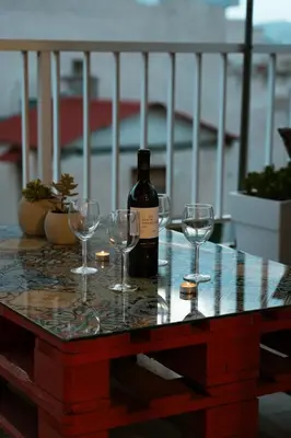 a bottle of wine and wine glasses on a table at AcroLofts M62 in Athens