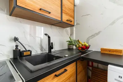a kitchen with a sink and a bowl of fruit at AcroLofts M62 in Athens