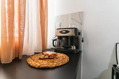a coffee maker and a plate of food on a counter at AcroLofts M62 in Athens