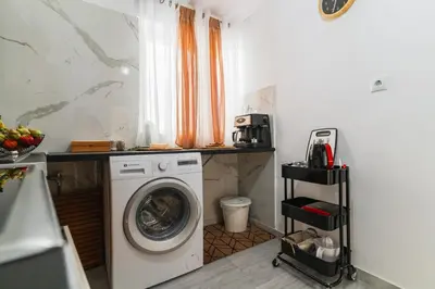 a laundry room with a washing machine in it at AcroLofts M62 in Athens