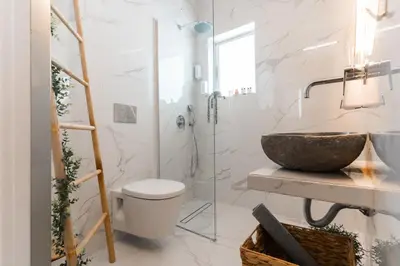a bathroom with a sink toilet and a glass shower at AcroLofts M62 in Athens