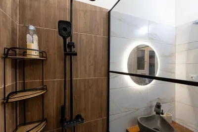 a bathroom with a sink and a mirror at Elegant 2 Bedroom Apartment - near National Museum in Athens