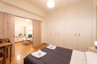 a bedroom with a bed with two towels at Elegant 2 Bedroom Apartment - near National Museum in Athens