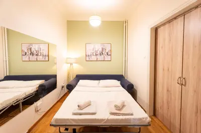 a small room with two beds in it at Elegant 2 Bedroom Apartment - near National Museum in Athens