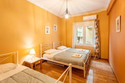 a bedroom with two beds and a window at Renovated 2 Bedroom Apartment in City Centre in Athens