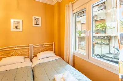 a bedroom with a bed next to a window at Renovated 2 Bedroom Apartment in City Centre in Athens