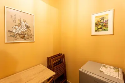 a room with two pictures on the wall and a table at Renovated 2 Bedroom Apartment in City Centre in Athens