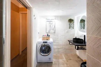 a washer and dryer in a room with a hallway at Renovated 2 Bedroom Apartment in City Centre in Athens