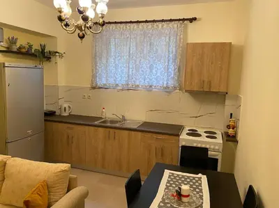 a kitchen with a table and a stove and a window at DS Apartment (semi-basement) in Athens