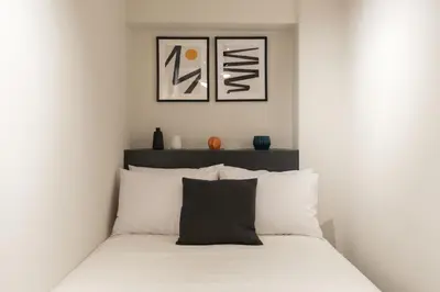 a white bedroom with a bed with white pillows at Voda Luxury Residence #001 - Acropolis View Rooftop in Athens