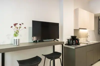 a kitchen with two chairs and a tv on a counter at Voda Luxury Residence #001 - Acropolis View Rooftop in Athens