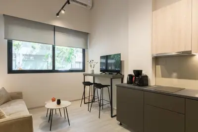 a kitchen and living room with a couch and a table at Voda Luxury Residence #001 - Acropolis View Rooftop in Athens