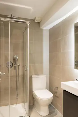 a bathroom with a toilet and a shower and a sink at Voda Luxury Residence #001 - Acropolis View Rooftop in Athens