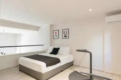 a white bedroom with a bed and a window at Voda Luxury Residence #002 - Acropolis View Rooftop in Athens